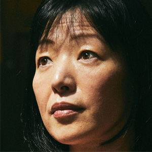 Closeup of Akiko Iwasaki of the Yale School of Medicine against a dark background.