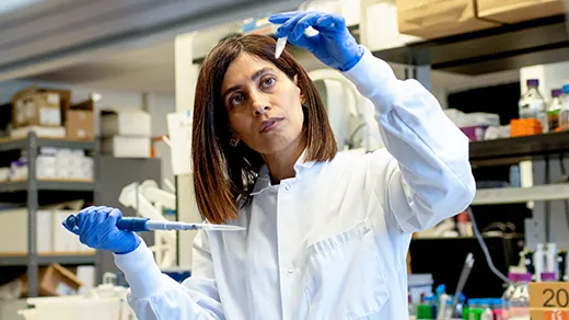 Nikta Fakhri looks at a test tube.